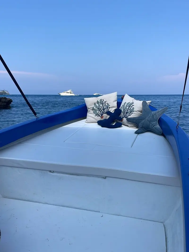 Bow of the boat with cushions at sunset